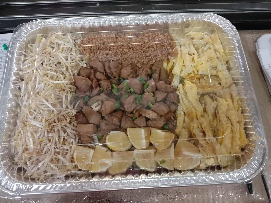 Phad Thai Pacita kitchen with orange wok sealing machine — used for their signature cooler cups
